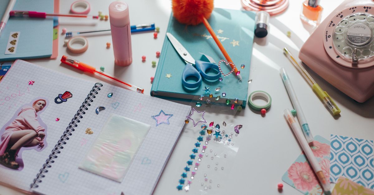A vibrant workspace filled with crafting materials, stationery, and decorative items promoting creativity.