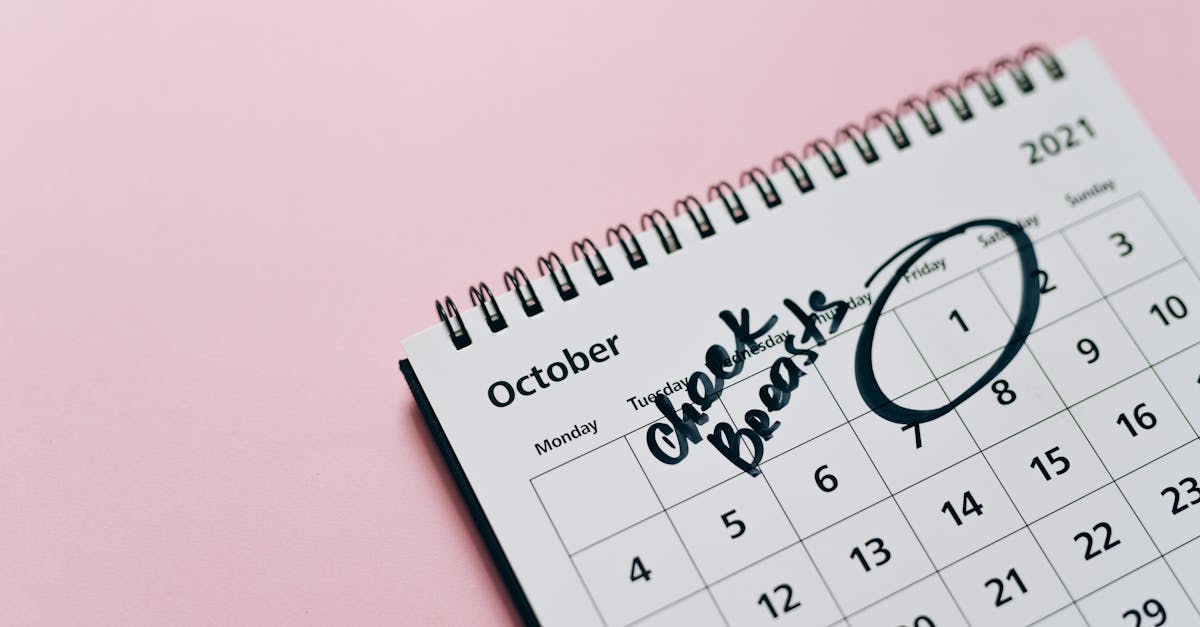 October calendar with breast check reminder, emphasizing health awareness on a pink background.