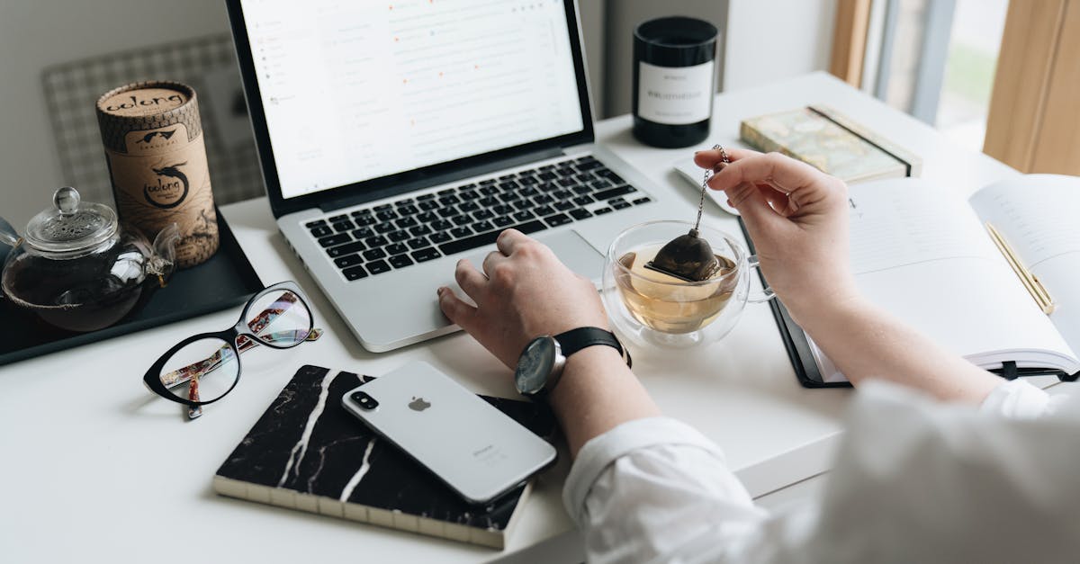 A cozy home office scene with a laptop, tea, and workspace essentials.