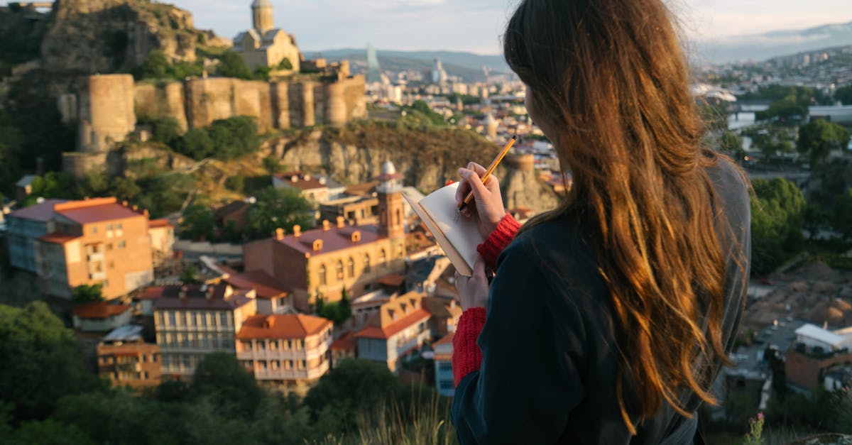 Woman writing in journal with a historic city view in the background, capturing inspiration from a stunning ci