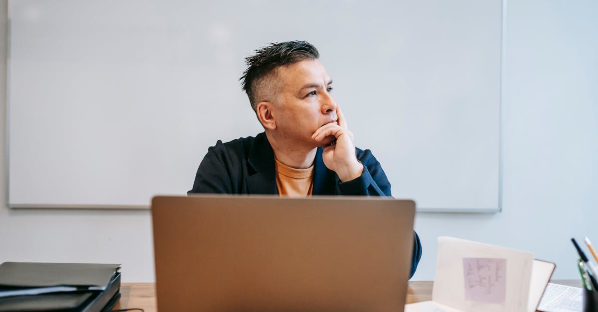 Focused businessman in home office, pondering work thoughts. Perfect for remote work and telecommuting concept