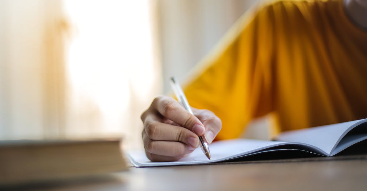 Close-up of a person writing in a notebook, symbolizing focus and learning.