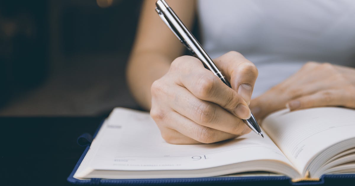 Woman writing in a notebook, capturing a moment of focused concentration.