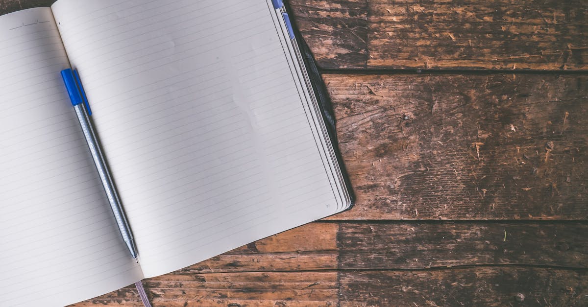 Person holding a notebook with planning details and graph for business strategy indoors.