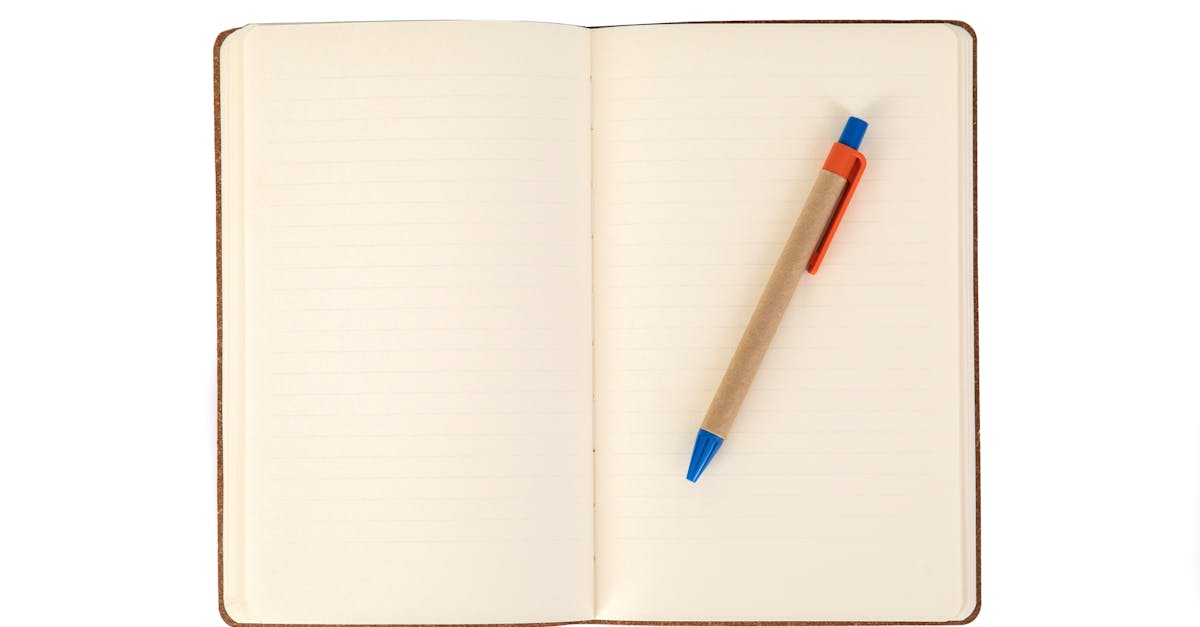 A minimalistic image featuring an open notebook with a pen placed on its pages, offering ample copy space.