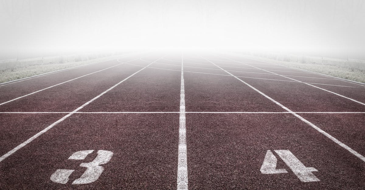 A foggy track field with visible lane numbers and white lines.