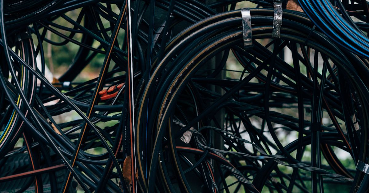 Close-up view of a complex tangle of electrical wires outdoors.