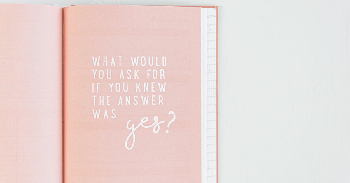 Open pink notebook with an inspirational quote in white text.